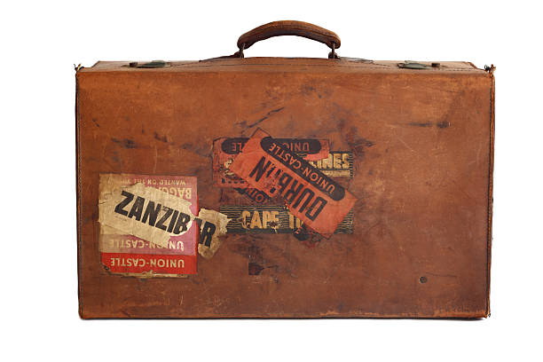 old leather suitcase with stickers Side view of a well used old leather suitcase used for ocean travel to Africa in mid 1900's. Some stickers visible - shows the words Zanzibar and Durban and Union Castle. Union Castle was a shipping line running between Southhampton and South Africa but stopped operating in 1977. old luggage tag stock pictures, royalty-free photos & images