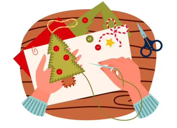 Vector illustration of Top view on table with hands sewing felt christmas decoration.  Sewing christmas tree , DIY. Cartoon vector illustration