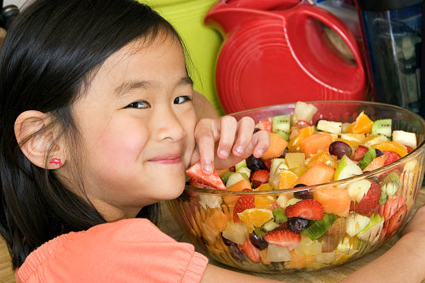 istock Cute Asian girl with fruit 182740792
