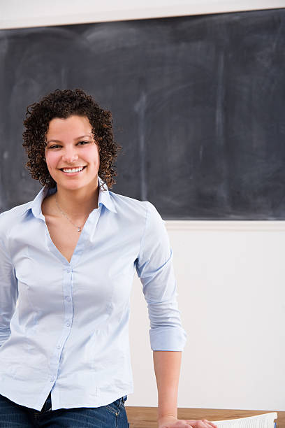 istock Attractive Female Teacher or Student Leaning on a Desk 182740946
