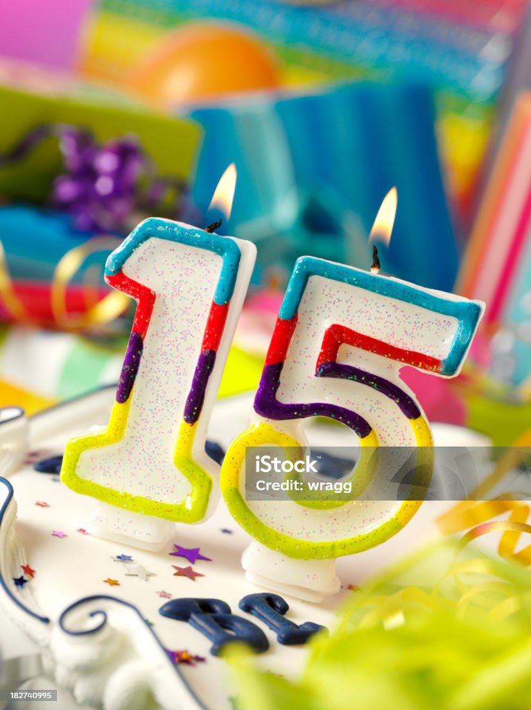Number Fifteen Birthday Candle Number fifteen birthday candle with differential focus on the gifts. Birthday Stock Photo
