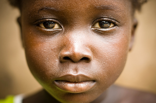 A close up of an African girls face.
