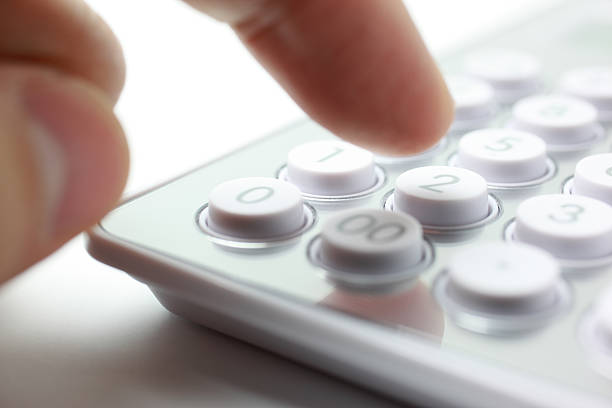 Calculating Close-up of fingers pushing on calculator. types of loans stock pictures, royalty-free photos & images