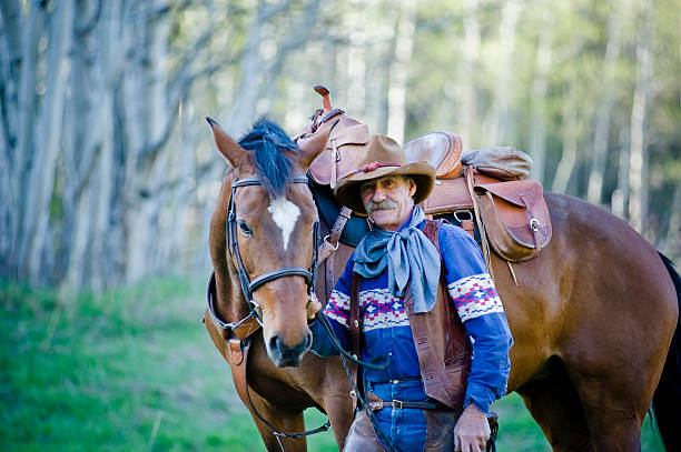istock Old cowboy with horse in woods 182741727