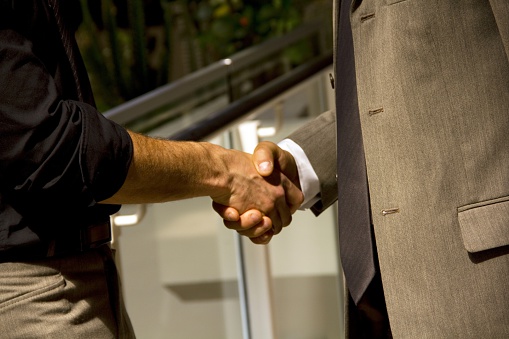 Hands shake two business people