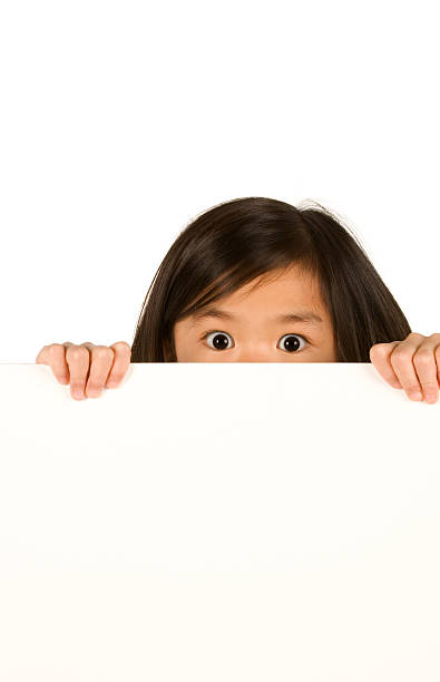 istock Chinese girl peeking over sign 182742243