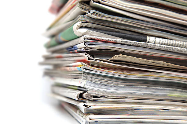 istock Large stack of newspapers and magazines on white background. 182742951