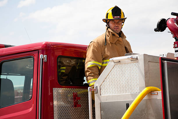 istock Firefighter Looking Out at Fire from Firetruck 182743229
