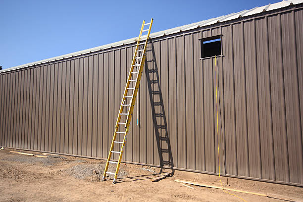 Ladder leaning on metal building
