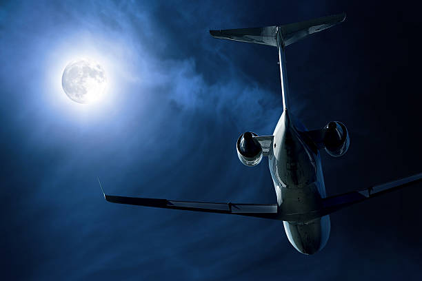 Photo of corporate jet airplane taking off at night