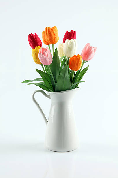 White pitcher full of colorful blooming flowershttp://www.twodozendesign.info/i/1.png