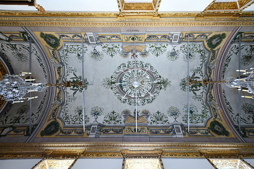 A typical old fashioned patterned cornice between the interior wall and ceiling in a European house.