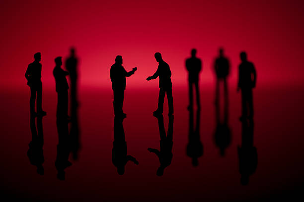 istock Group of businessmen silhouettes on red background 182744767