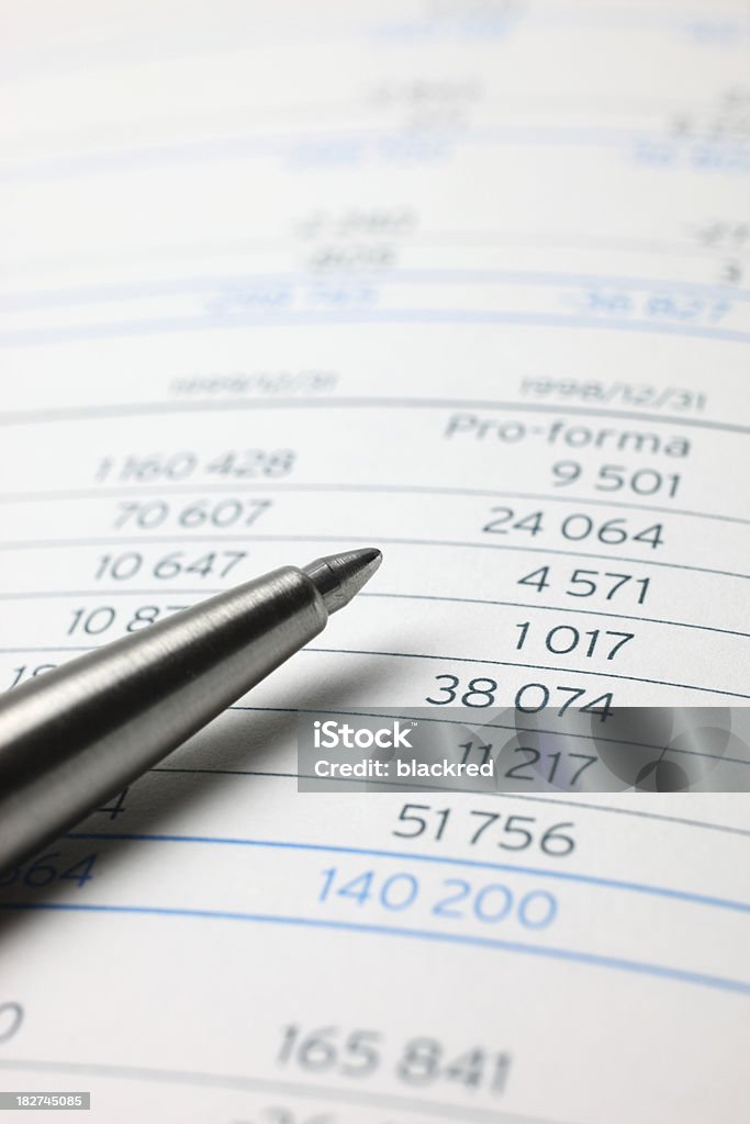 Financial Figures Close-up of a pen on financial figures. Aspirations Stock Photo