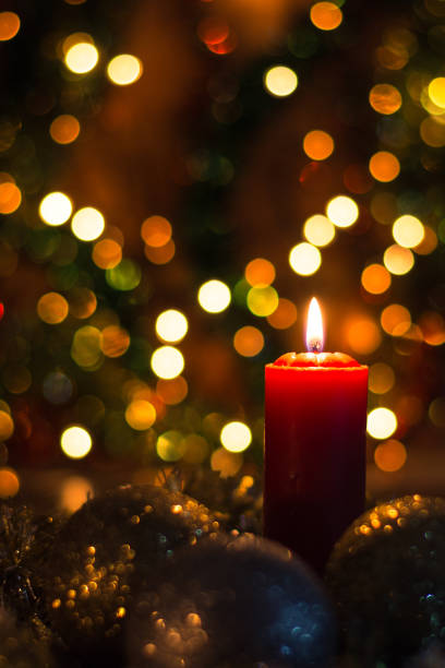 istock Candles and Christmas decorations on dark background with lights 1827451032