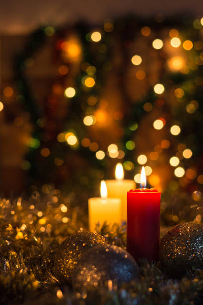 istock Candles and Christmas decorations on dark background with lights 1827451981
