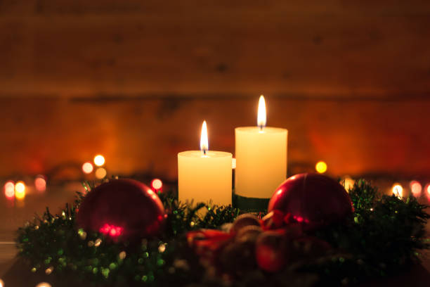istock Candles and Christmas decorations on dark background with lights 1827452079