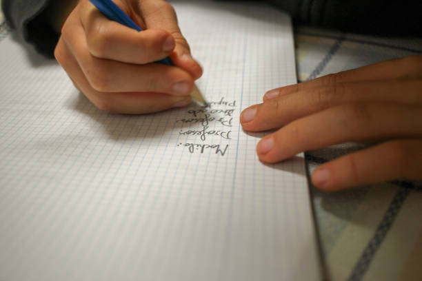 istock writing French to do his homework 1827468475