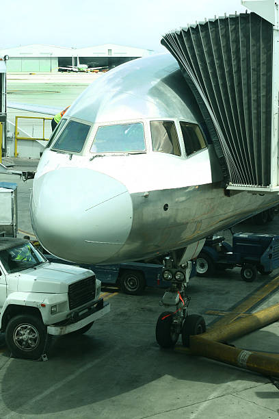 istock Jet being serviced. Jetway up to door. Vertical. 182746921