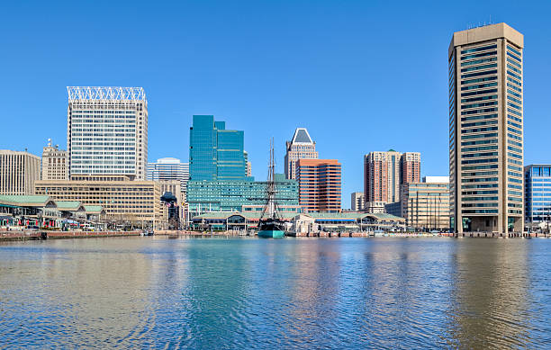 istock Baltimore's Inner Harbor Buildings Reflecting in Water Under Blue Sky 182747164