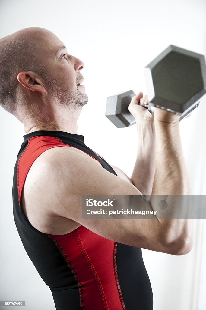 Senior Lifting Weights An older man lifts weights. Active Lifestyle Stock Photo