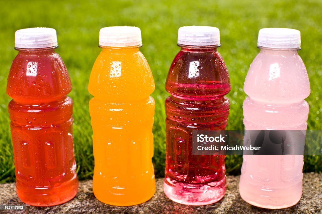 four multi colored sports drinks "Four multi colored sports drinks sit, just waiting to be gulped up!" Sport Drink Stock Photo