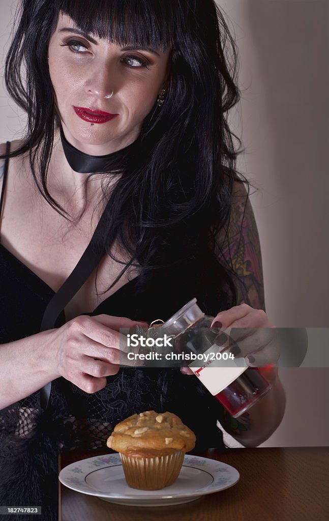 femme fatale "woman about to add poison to a muffin, concept of femme fatale" 30-39 Years Stock Photo