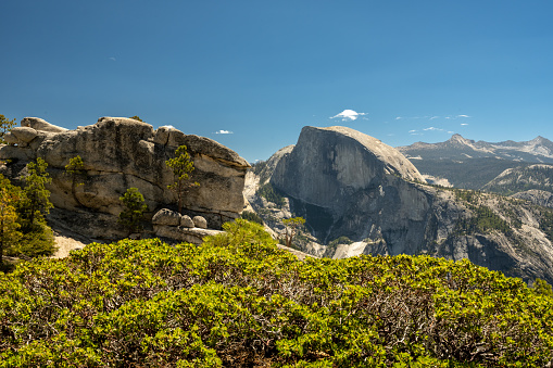 Large Rocks On Yosemite Point With Half Dome In The Background in summer