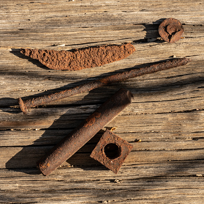 Rusty Connectors On Display on wooden surface
