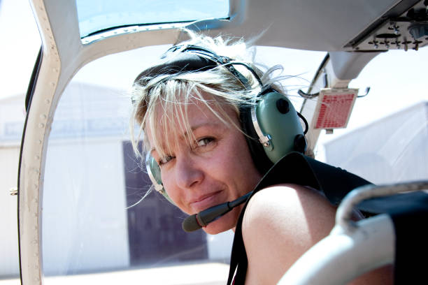 istock Adventurous Woman in Helicopter with headset 182749605