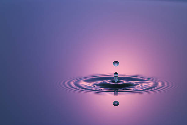 istock Closeup Stop Action Water Drop in Magenta 182750296