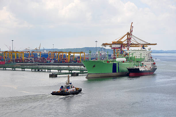 An oil tanker discharging cargo to terminal pipeline.