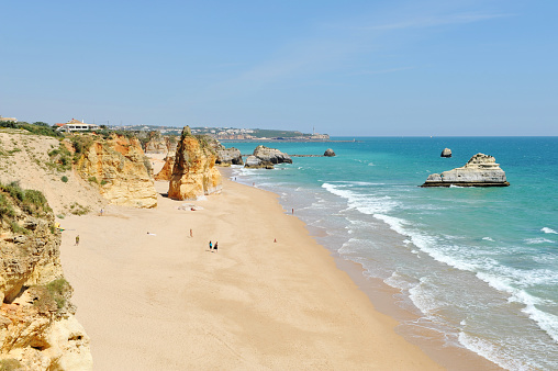 Coastline with colorful rock formations and a turquoise sea near Portimao,Algarve,Portugal.