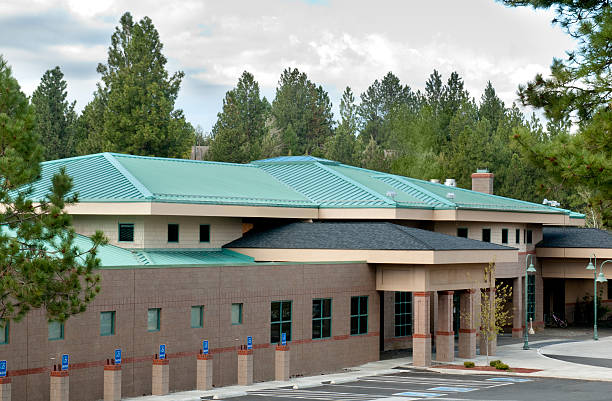Green metal roofing w/building exterior stock photo