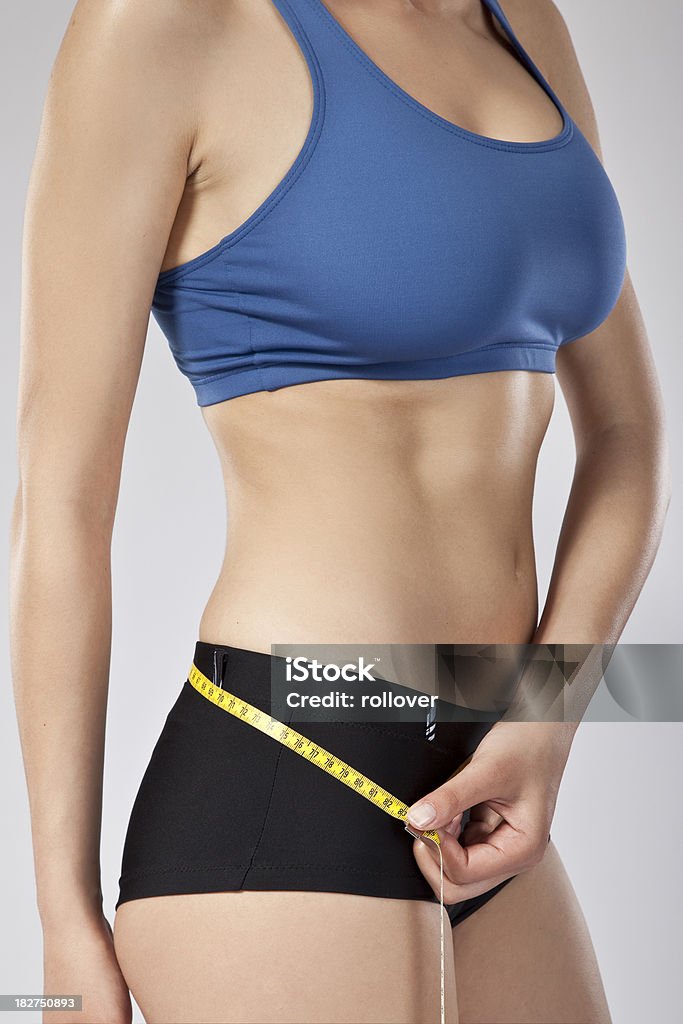 Woman measuring her waist Abdomen Stock Photo