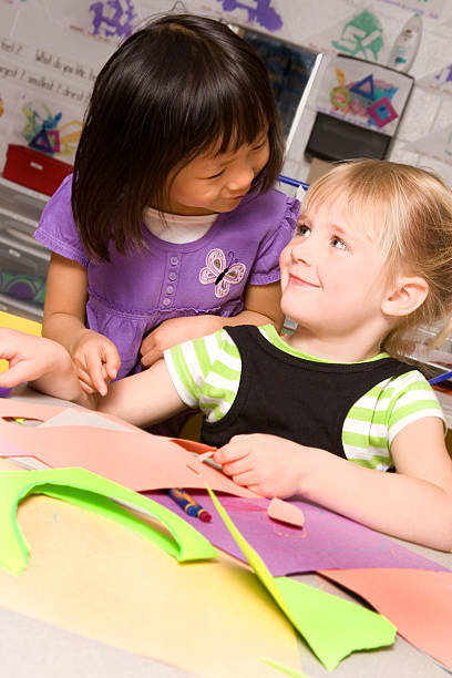istock Preschooler helping her friend 182751060