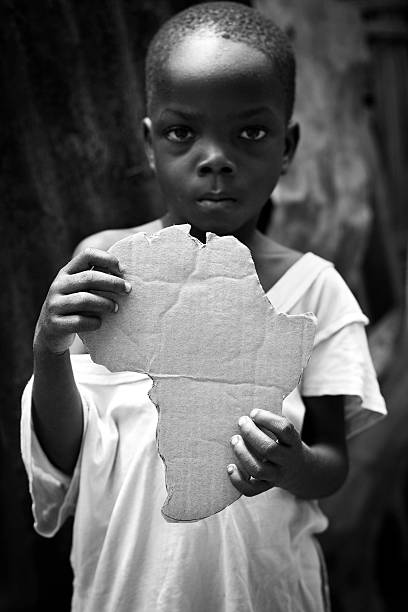 istock African Boy Holding An Africa Shaped Cutout 182751580