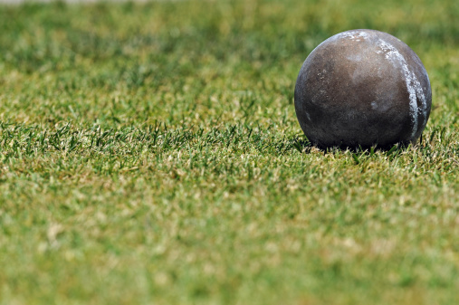 Shot put ball on grass.
