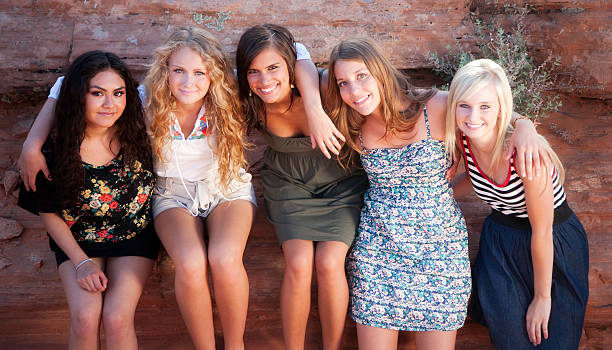 Group of 5 Diverse and Beautiful Friends Hanging Out "Beautiful and diverse friends spending time together outside.Shot with Canon 1Ds Mark II, image processed from a 16 bit RAW file.Shot at RedRockalypse 5" hazel blue eyes stock pictures, royalty-free photos & images