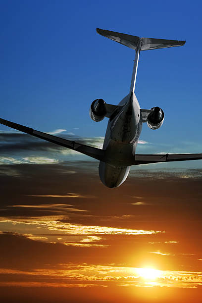 istock corporate jet airplane flying at sunset 182751970