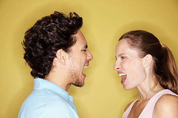 istock Angry couple yelling at each other against yellow background 182752027