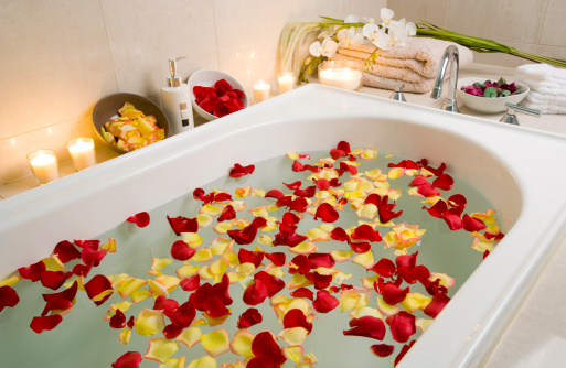 Spa treatment bathtub with floating rose petals and candlesPeople who liked this image also liked these: