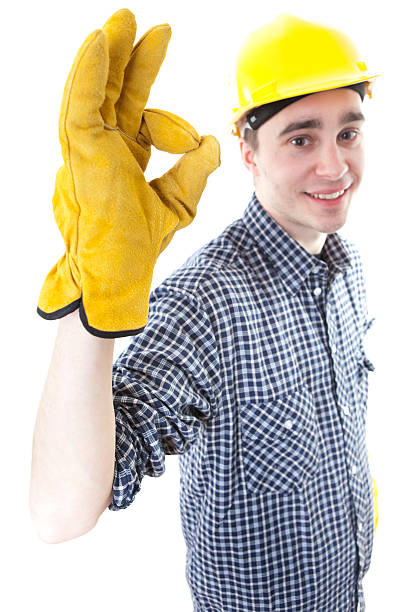 istock Young construction worker with yellow helmet doing OK sign 182752780