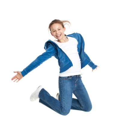 ten years old happy girl jumping isolated on white