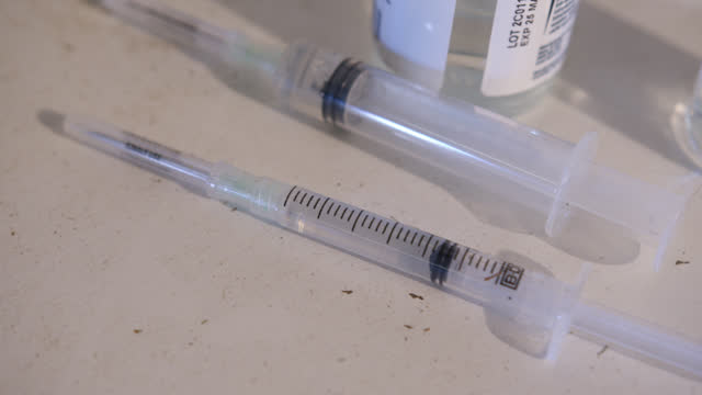 Close-Up of Syringes and a Glass Vaccine Vial