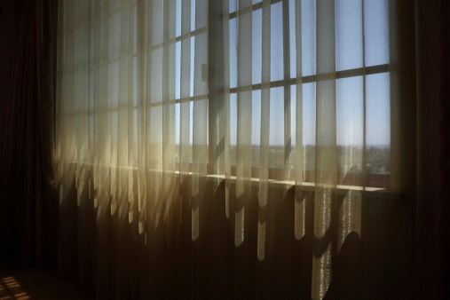 Back lit curtains in a room.