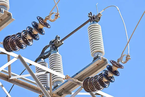 Photo of electricity substation with power lines and insulators