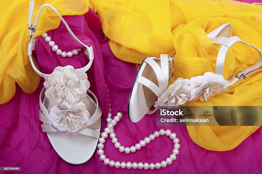 Wedding shoes on pink and yellow silk Bracelet Stock Photo