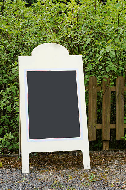 istock empty wooden blackboard in front of fence 182754890