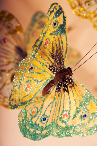 Fake sparkly butterfly montage. (Mass produced decoration)Shallow DOF.